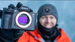 Sony a7 mirrorless camera with sensor visible, held up to display purple filter coating.