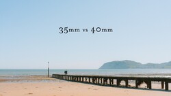 Wooden pier extending into a beach with mountains visible across the water, labeled comparing 35mm vs 40mm focal lengths.