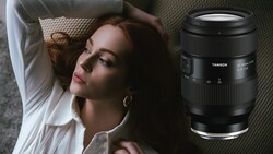 Woman lying on textured bedding with a Tamron lens displayed beside her.