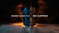 Sigma 15mm f1.4 lens with blue and black coloring positioned on reflective surface with warm atmospheric lighting and smoke effect in background.