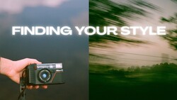 Hand holding a vintage rangefinder camera against a blurred mountainous landscape background.