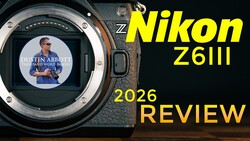 Nikon Z6III camera body with open mirror cavity and LCD screen displaying a tutorial video.