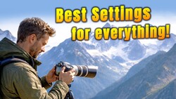 Photographer with telephoto lens photographing snow-capped mountains in bright daylight.