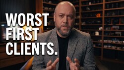 Man in gray blazer speaking directly to camera with hands gesturing, with text overlay reading "WORST FIRST CLIENTS."
