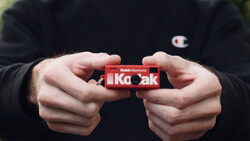 Hands holding a red Kodak Portra film box