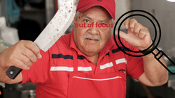 Man in red work uniform holding curved tool, with magnifying glass graphic overlay