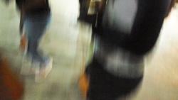 Blurred motion photograph of people walking indoors