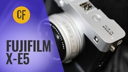 Fujifilm X-E5 mirrorless camera with interchangeable lens against purple and black background