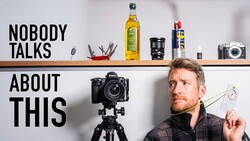 Photographer holding light meter next to camera on tripod with text overlay 'Nobody Talks About This'