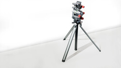 Professional camera rig mounted on tripod with fluid head and red control knobs