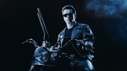 Man in leather jacket and sunglasses sitting on motorcycle against dark blue background