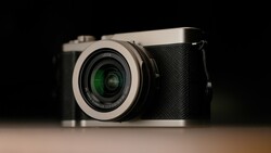 Leica Q2 rangefinder camera with silver top plate and black body on neutral background