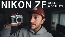 Man holding vintage Nikon ZF rangefinder camera with text overlay asking 'Still Worth It?'