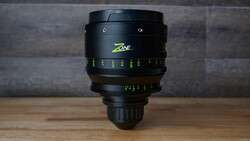 Zeiss Zone cinema lens with yellow focus markings mounted on wooden surface