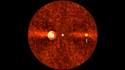 Thermal or infrared imaging illustration showing a circular red sphere with two bright hot spots and a central crosshair marker