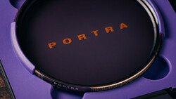 Portra film stock container displayed on purple surface with dramatic lighting