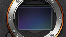 Camera sensor and mirror assembly viewed through open mount showing blue-tinted sensor surface