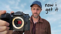Man holding OM System camera body with exposed sensor and text 'now i get it'