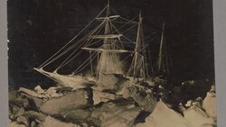 Sailing ship trapped in pack ice under starry night sky