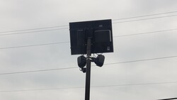 LED light panel mounted on a pole against a cloudy sky