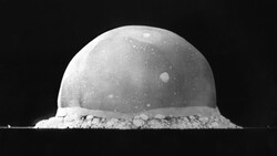 Monochrome photograph of a spherical dome-shaped object with granular base material against black background