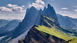 Säntis mountain peak with dramatic vertical rock formations and green alpine meadows in Swiss Alps