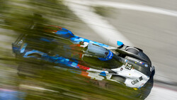 Two bobsleds racing down an icy track with motion blur