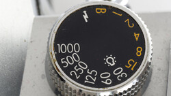 Close-up of camera aperture dial with f-stop numbers and shutter speed markings