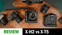 Fujifilm X-H2 and X-T5 cameras with lenses arranged on wooden surface for comparison review