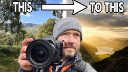 Photographer holding Nikon DSLR camera with golden hour landscape in background