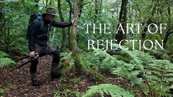 Hiker on forest trail with text overlay reading 'The Art of Rejection'