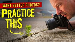 Photographer shooting macro of small plant sprout at ground level with DSLR camera