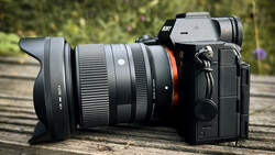 Sony mirrorless camera with wide-angle lens on wooden surface outdoors