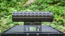 AGO gun rail system mounted on black tactical handguard with green foliage background