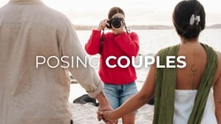 Photographer in red jacket taking portrait of couple holding hands by waterside