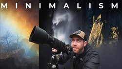 Photographer holding a large telephoto lens with dramatic landscape backdrops