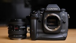 Contax N camera body with telephoto lens on wooden surface