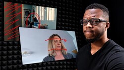 Male photographer demonstrating head tracking technology with overlay graphics on monitor showing facial mapping