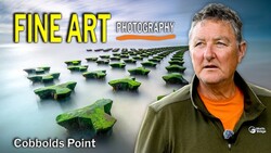 Photographer at Cobbolds Point with long exposure seascape of moss-covered rocks in flowing water