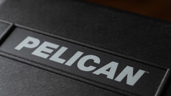 Logo for Pelican, white lettering on a black protective equipment case, shown in close-up at an angle.