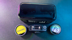 Mobile phone with two external lens attachments labeled Insta360 and FS, arranged on colorful gradient background