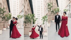 Couple in formal attire dancing and posing in urban courtyard with modern buildings