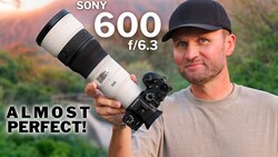 Man holding Sony 600mm f/6.3 telephoto lens mounted on camera body