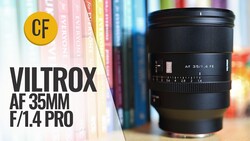 Black Viltrox AF 35mm f/1.4 Pro FE lens on a wooden shelf before colorful book spines, with a review title overlay.