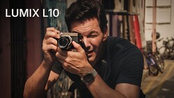 Photographer holding Lumix L10 camera in shooting position, looking through viewfinder