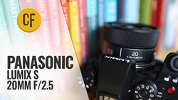 Panasonic Lumix S 20mm f/2.5 lens mounted on camera body with colorful book spines blurred in background