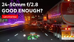 Highway night scene with truck and neon signs, with text overlay asking if a 24-50mm f/2.8 lens is adequate