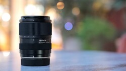Tamron lens mounted on surface with blurred bokeh background
