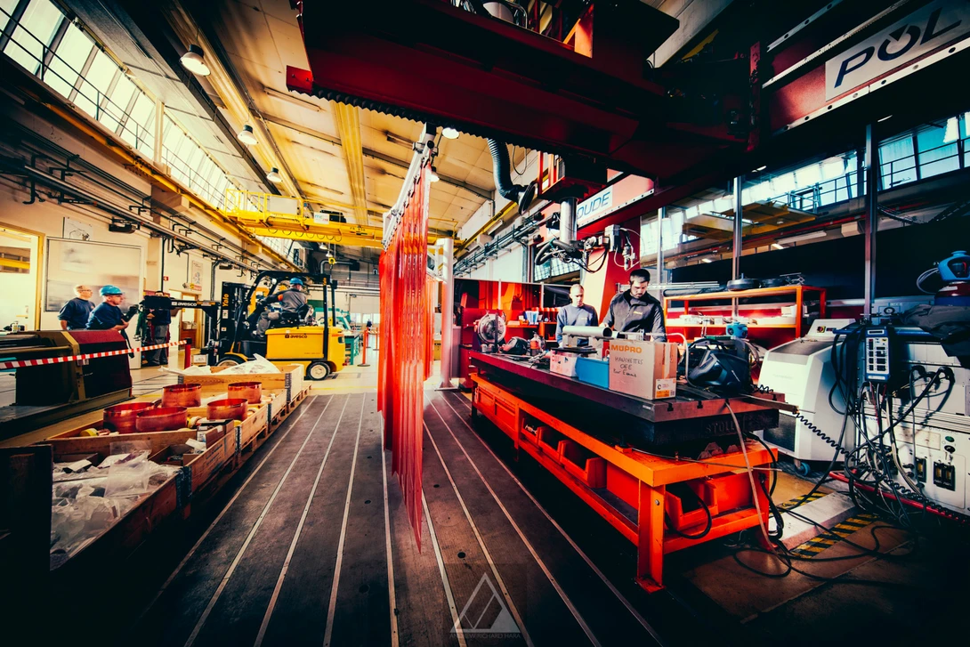 Machinists work on a welding robot at the CERN Main Workshop - Photo by Andrew Hara