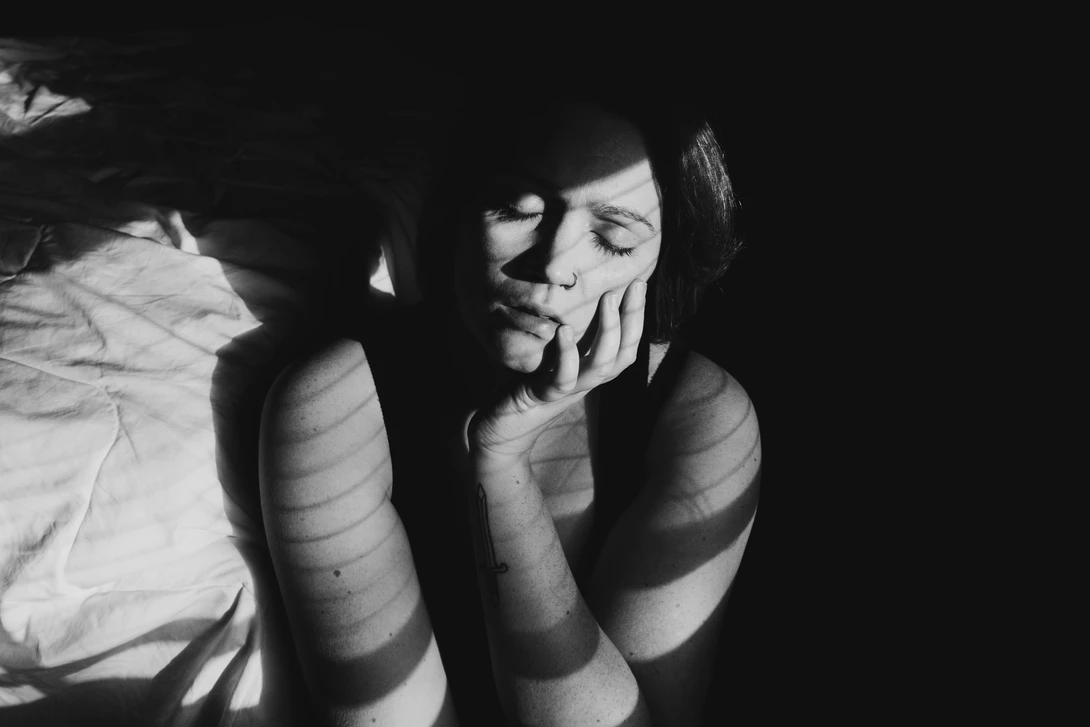 Black and white portrait using hard window light and shadows